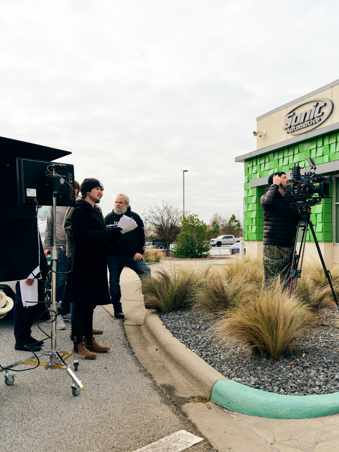 Echo Park BTS — director reviewing playback outside dealership