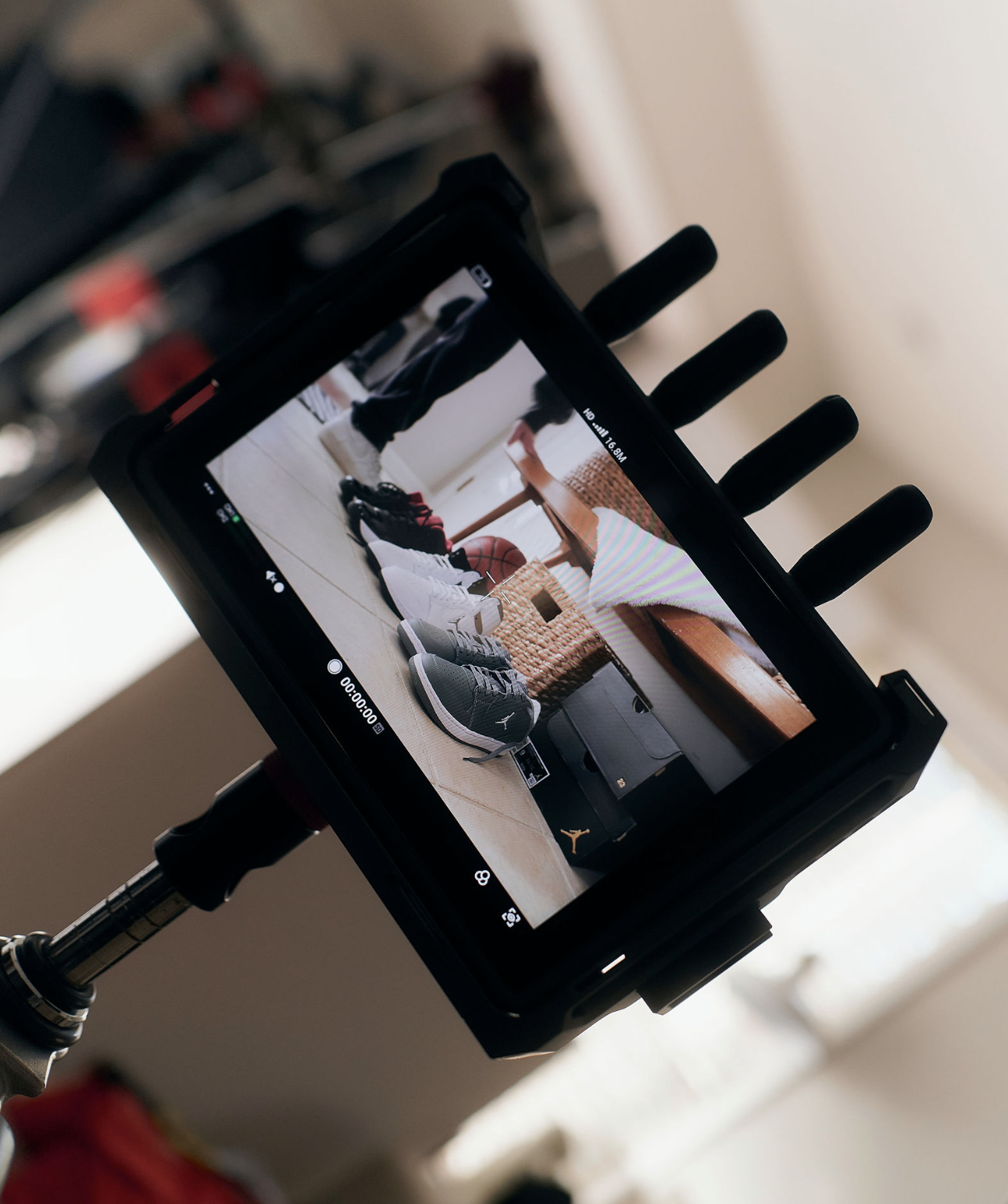 Rack Room BTS — close-up of monitor framing Jordans