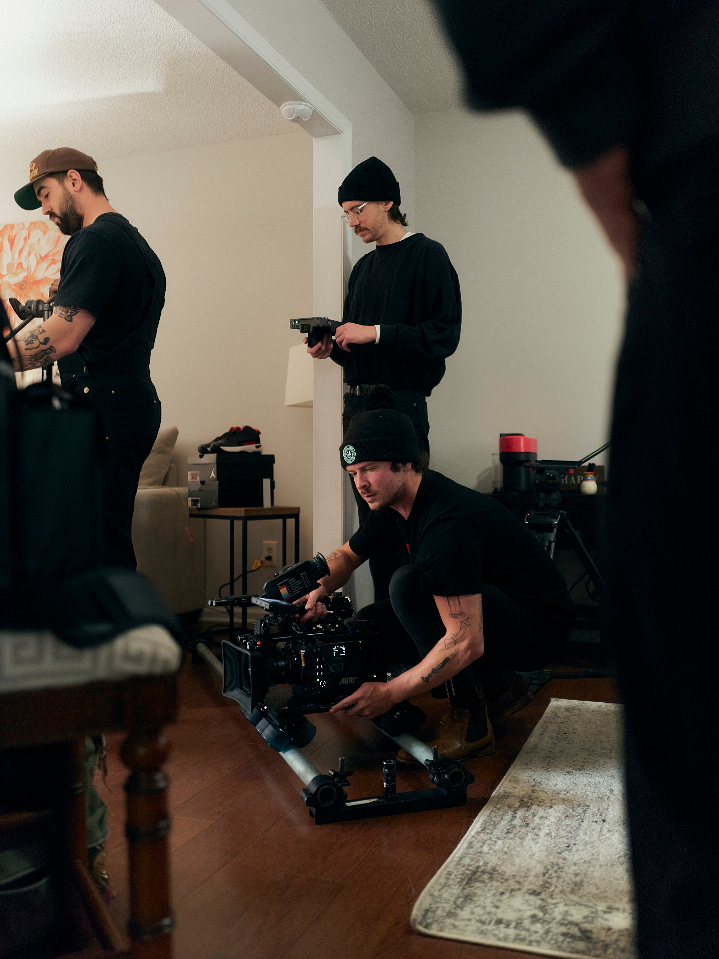 Rack Room BTS — crew setting up camera on dolly